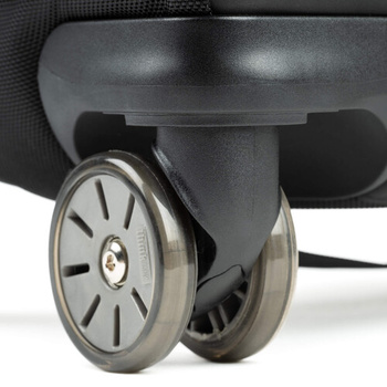 Close-up of a luggage wheel assembly with metallic finish and rubber tire against dark background.