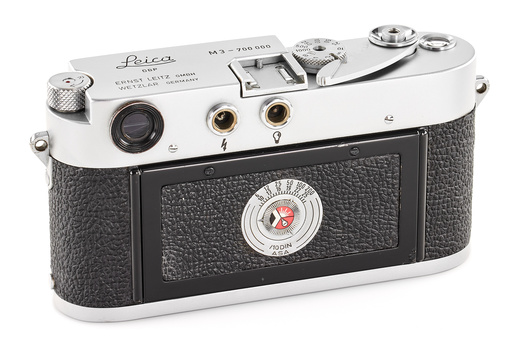 Leica M3 rangefinder camera with chrome top plate and black textured leather body.