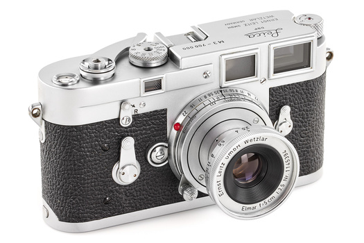 Leica M3 rangefinder camera with chrome top plate and black leather body, shown from three-quarter angle with lens attached.