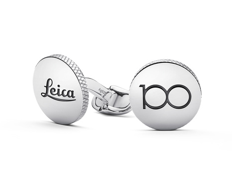 Silver cufflinks with Leica and 100 logo designs connected by chain link.