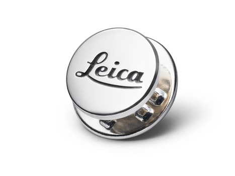 Leica lens cap with chrome metal base and white top featuring the Leica script logo.