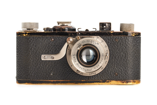 Vintage rangefinder camera with black leather body and chrome lens assembly.