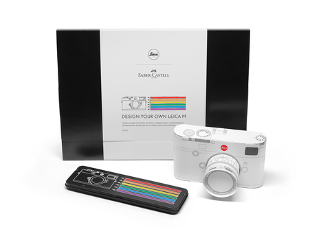 Faber-Castell Leica M kit with white rangefinder camera, rainbow strap, and black carrying case.