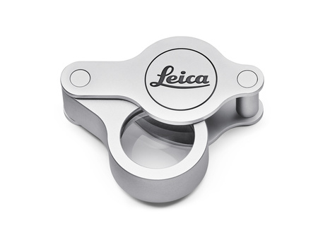 Leica lens cap with tripod socket mount, silver aluminum construction with hinged design.