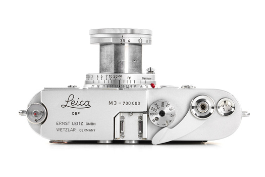 Top-down view of a Leica M3 rangefinder camera with chrome body and mounted lens.