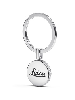 Chrome keychain with spherical pendant bearing Leica engraving, shown against white background.