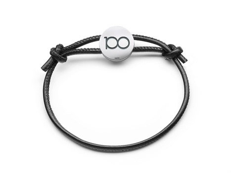 Black cord bracelet with silver circular charm engraved with infinity symbol.