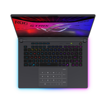 Top-down view of a gaming laptop with illuminated keyboard and colorful gradient display wallpaper.