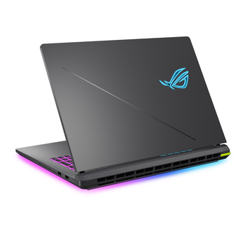 ASUS ROG gaming laptop with closed lid showing illuminated logo and RGB lighting around base.