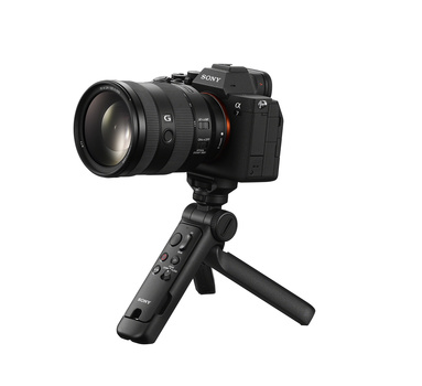 Sony mirrorless camera with attached lens mounted on a compact handheld gimbal stabilizer against white background.