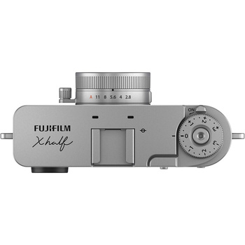 Top-down view of a silver rangefinder camera with attached lens and manual controls.