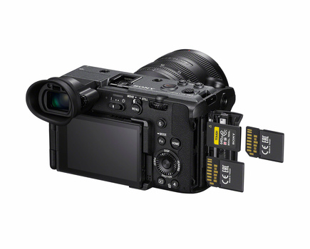 Professional video camera with articulating screen and dual SD card slots open on the right side.