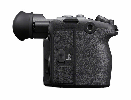 Compact mirrorless camera with electronic viewfinder attachment and textured grip, shown from side angle.