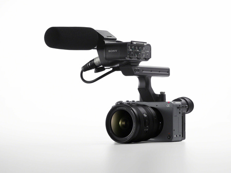 Sony cinema camera mounted on a support rig with a directional microphone and zoom lens attached.