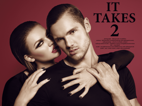 Two people in black clothing posed closely against a burgundy background with dramatic studio lighting.