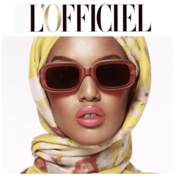 Person wearing oversized red-tinted sunglasses and yellow patterned headwrap against white background.