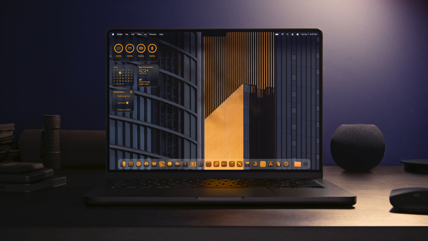 Laptop displaying architectural visualization with golden and dark blue lighting against a dark studio backdrop.