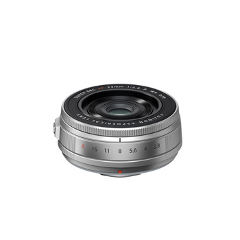 Silver compact prime lens with aperture ring and distance scale markings displayed against white background.