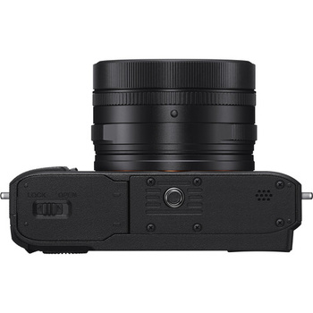 Top-down view of a mirrorless camera body with attached telephoto lens.