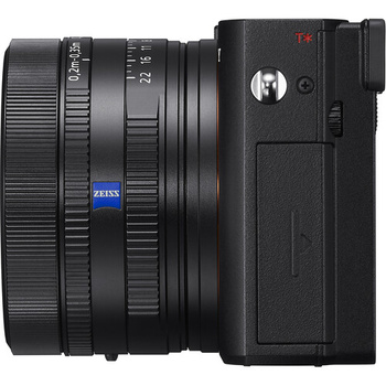 Sony mirrorless camera with Zeiss prime lens attached, shown from the side profile view.