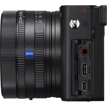 Sony compact camera with Zeiss lens shown from side profile displaying ports and controls.