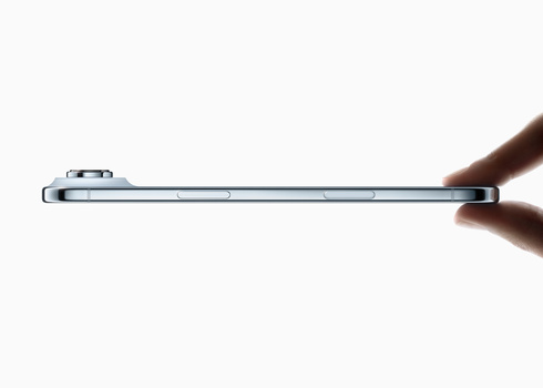 Thin metallic smartphone held horizontally, displaying sleek profile against white background.
