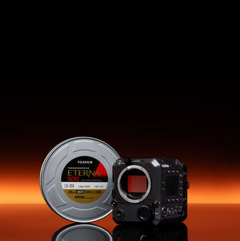 Fujifilm camera body next to a cinema lens with amber and orange gradient background.