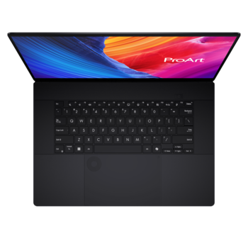 Overhead view of a laptop with black keyboard and colorful display showing abstract gradient design.
