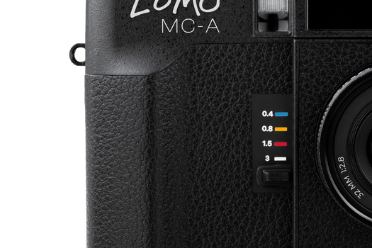 Close-up detail of a Lomography Fisheye camera body showing textured black finish and exposure compensation scale.