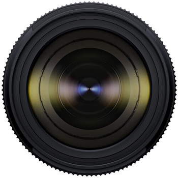 Close-up of a camera lens with multiple glass elements and a blue center reflection.