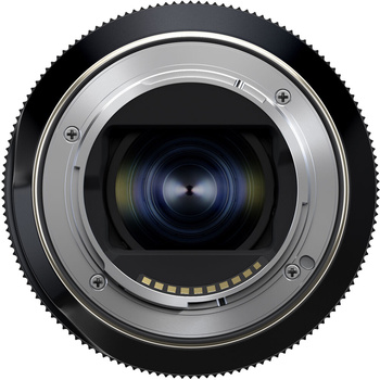 Rear view of a camera lens showing metal mount with blue optical elements visible through the glass center.