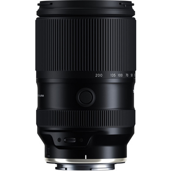 Black telephoto zoom lens with vertical ribbed grip and focus ring against white background.