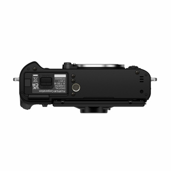 Top-down view of a mirrorless camera body showing controls, ports, and integrated grip against white background.