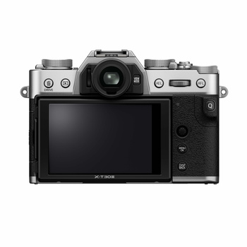 Mirrorless camera with silver body and black accents, shown from rear view with LCD screen displayed.