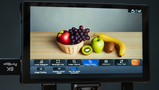 Screenshot of image editing software displaying a still life composition of fresh fruits on a wooden surface.