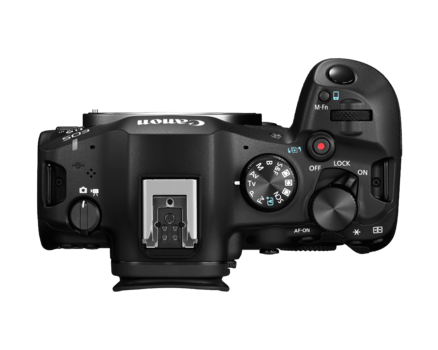 Top-down view of a black mirrorless camera body with articulating screen and manual controls.