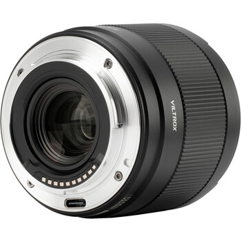 Camera lens with black rubber barrel and silver metal mount, shown in profile view.