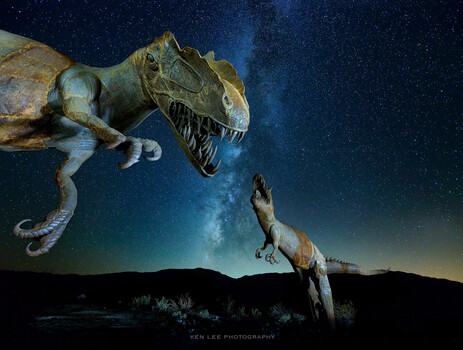 Two dinosaurs leaping against a starry night sky and silhouetted landscape.