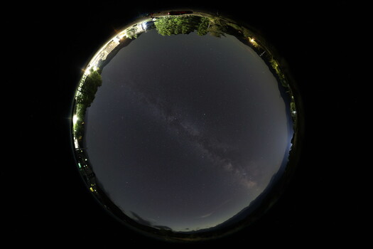 Panoramic planet view showing a 360-degree landscape with the Milky Way galaxy visible in the night sky.