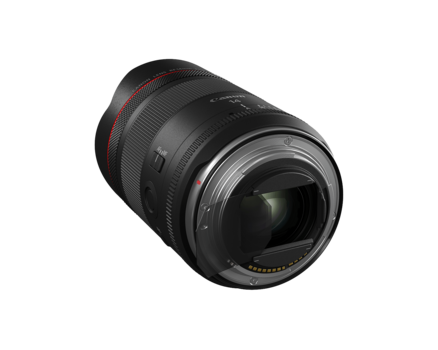 Black telephoto lens with red accents, photographed against a white background at a three-quarter angle.