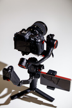 Professional cinema camera mounted on a motorized gimbal stabilizer with follow focus system.
