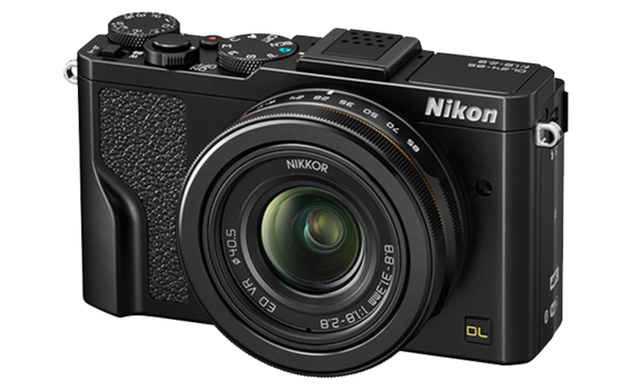 Nikon DL compact camera with fixed Nikkor lens, viewed from the right front at three-quarter angle.