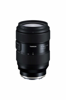 Black telephoto zoom lens with ribbed barrel and focus ring against white background.