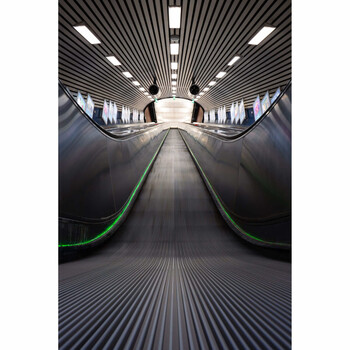 Symmetrical view down a modern airport moving walkway with converging lines and centered vanishing point.