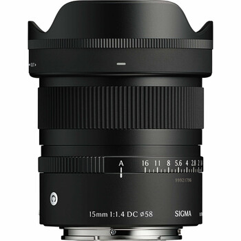 Sigma 15mm f/1.4 DC HSM Art lens with hood and aperture ring visible against white background.