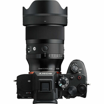 Sony Alpha 7 IV mirrorless camera with attached wide-angle lens and lens hood, shown from above against white background.