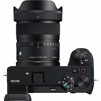 Top-down view of a mirrorless camera with wide-angle lens and hood attached.