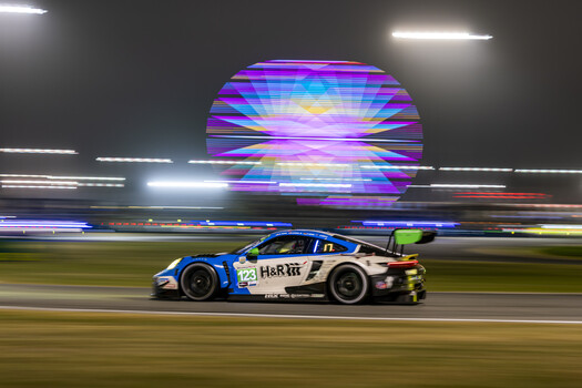The No. 123 Porsche enters turn three at Daytona in front of the Ferris wheel