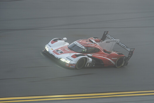 The No. 6 Porsche Penske on the high banking as the morning fog burned off. 