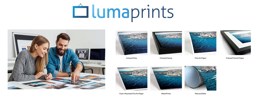Two professionals reviewing printed photos and canvas art samples at a desk with a computer monitor visible in the background.